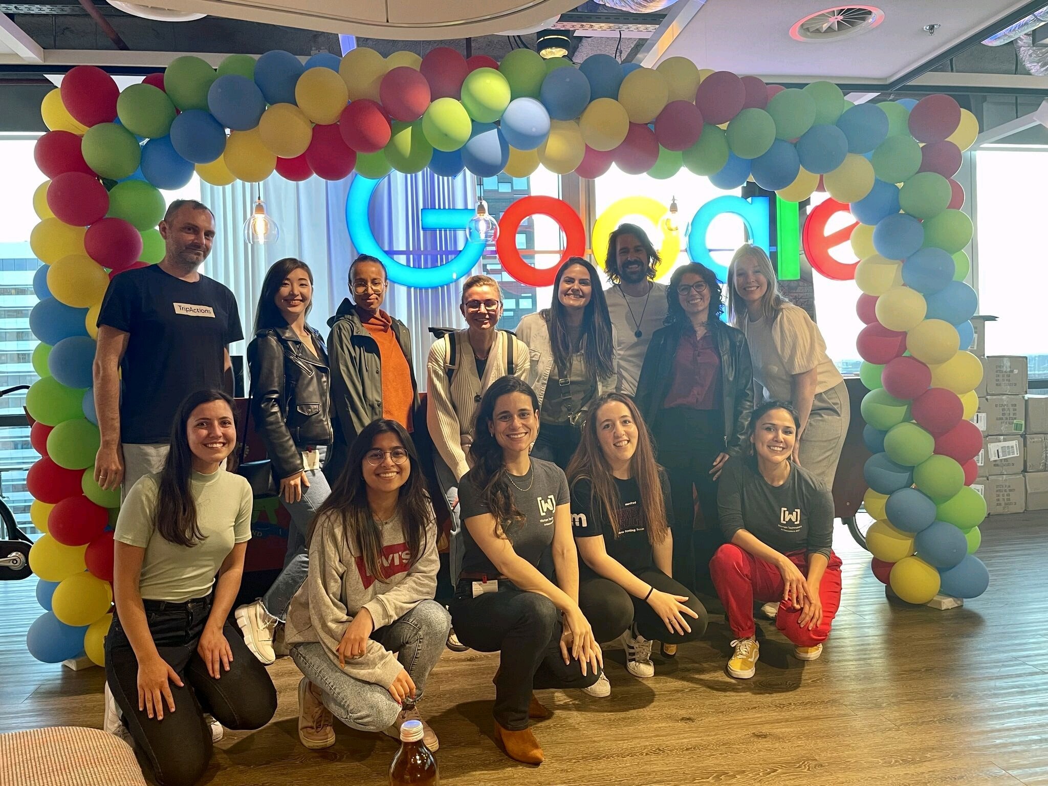 Alba and other attendees in front of a Google sign.